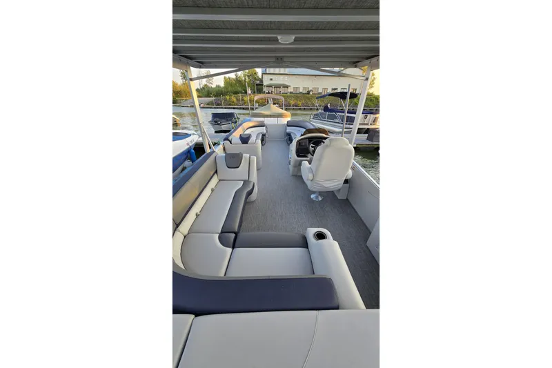 Slide: The Image of 2023 Avalon Catalina 2585 CRFS Funship interior with spacious seating and helm. - 14