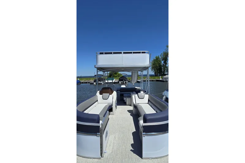 Slide: The Image of 2023 Avalon Catalina 2585 CRFS Funship pontoon boat with spacious seating on a sunny day. - 20
