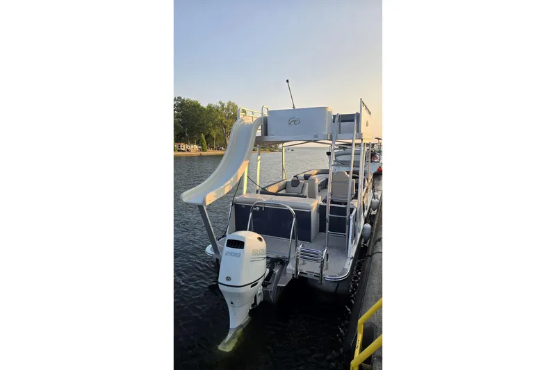 Slide: The Image of 2023 Avalon Catalina 2585 CRFS Funship pontoon boat with slide on a calm lake. - 3