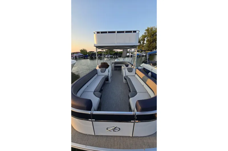 Slide: The Image of 2023 Avalon Catalina 2585 CRFS Funship pontoon boat interior at sunset. - 5