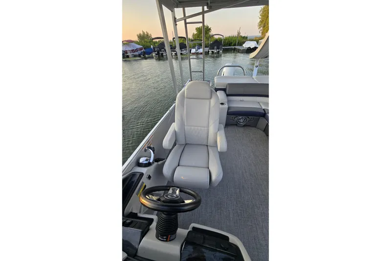 Slide: The Image of 2023 Avalon Catalina 2585 CRFS Funship interior with captain's chair and steering wheel. - 6