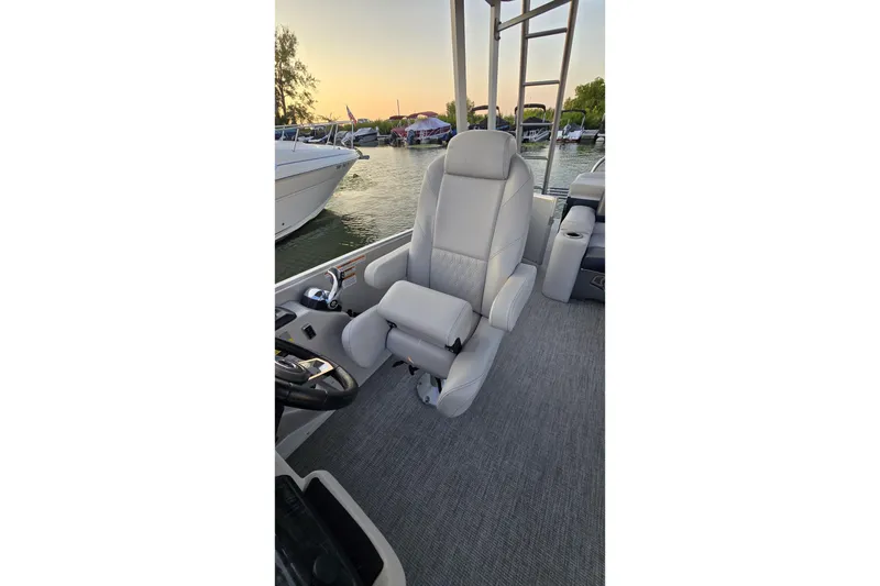 Slide: The Image of Captain's chair on 2023 Avalon Catalina 2585 CRFS Funship, docked at sunset. - 7