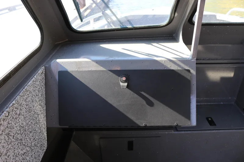 Slide: The Image of Interior view of 2026 Alumaweld Stryker 220 boat, showcasing dashboard and window design. - 10