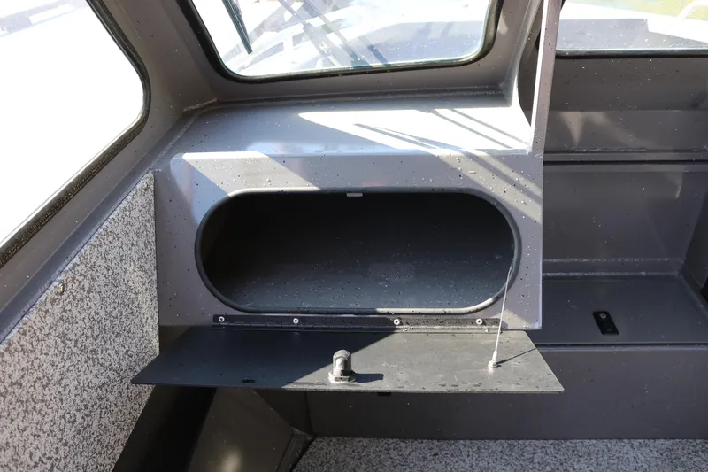 Slide: The Image of 2026 Alumaweld Stryker 220 boat interior storage compartment with open hatch. - 11