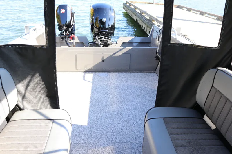 Slide: The Image of Interior view of 2026 Alumaweld Stryker 220 boat with dual outboard motors. - 12