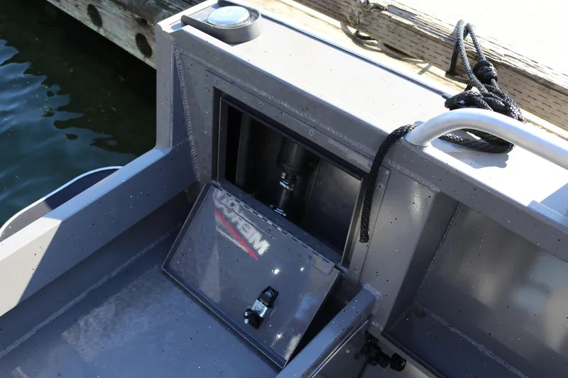 Slide: The Image of 2026 Alumaweld Stryker 220 boat interior detail with storage compartment and railing. - 17