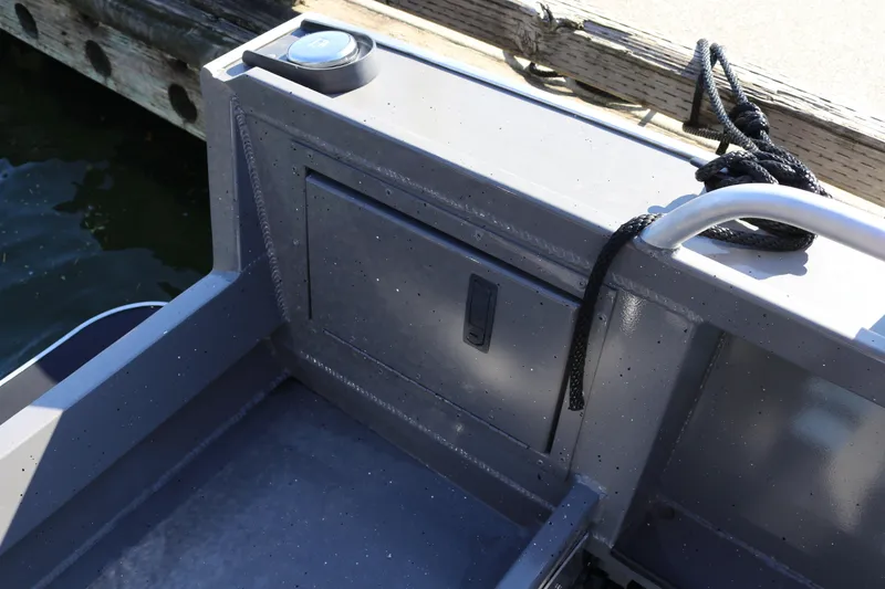 Slide: The Image of Alumaweld Stryker 220 boat interior detail, featuring storage compartment and railing, 2026 model. - 18