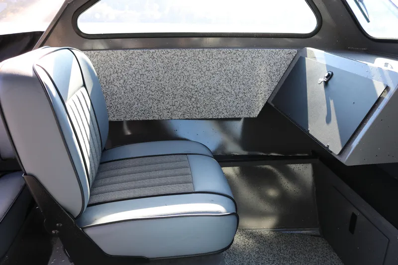 Slide: The Image of Interior of 2026 Alumaweld Stryker 220 boat with gray seating and storage compartment. - 21