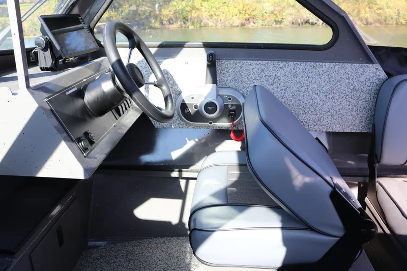Slide: The Image of 2026 Alumaweld Stryker 220 boat interior with steering wheel and seating. - 23