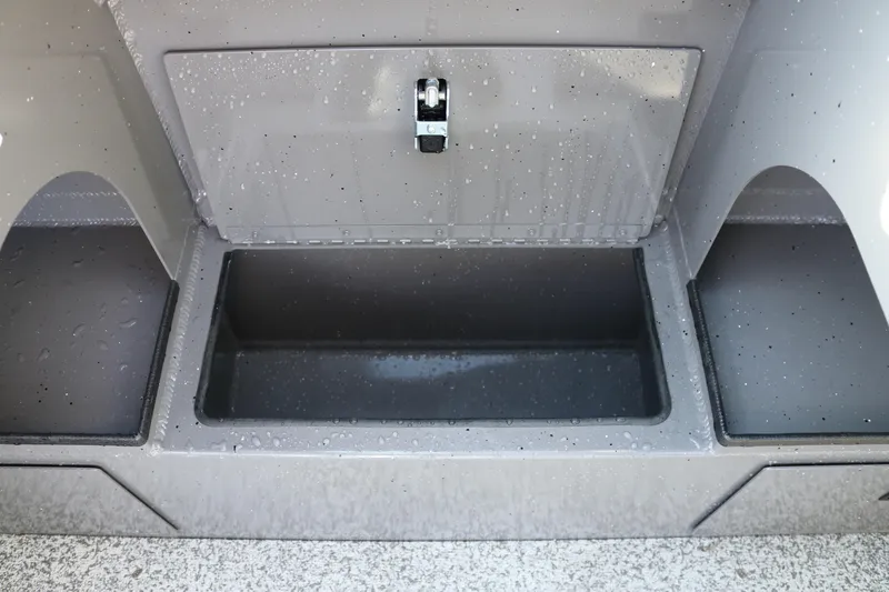 Slide: The Image of 2026 Alumaweld Stryker 220 boat storage compartment with water droplets on a gray surface. - 27