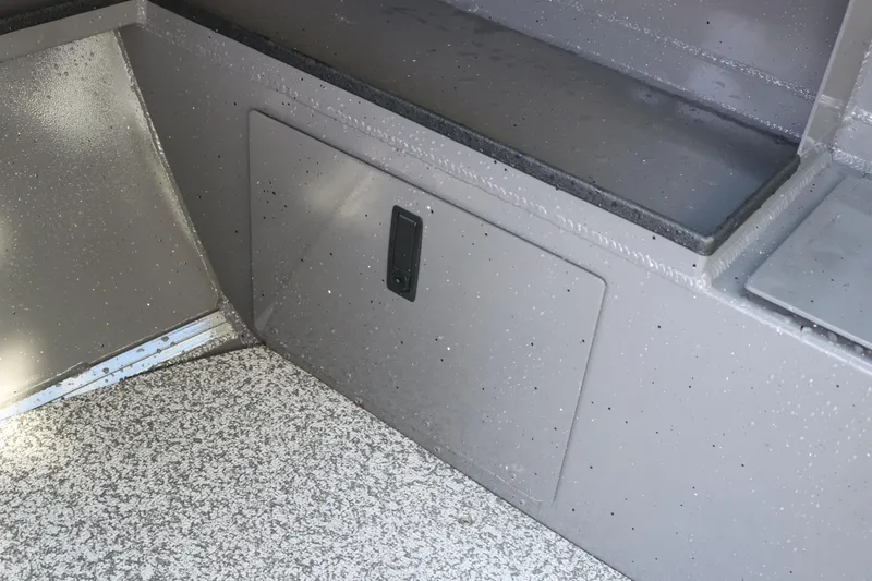 Slide: The Image of Alumaweld Stryker 220 boat interior storage compartment, 2026 model, with speckled flooring. - 28