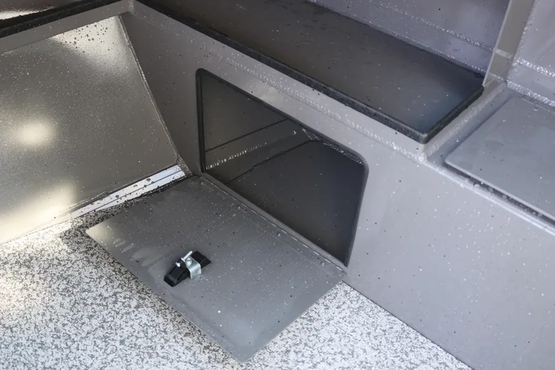 Slide: The Image of Interior detail of 2026 Alumaweld Stryker 220 boat, featuring storage compartment and latch. - 29