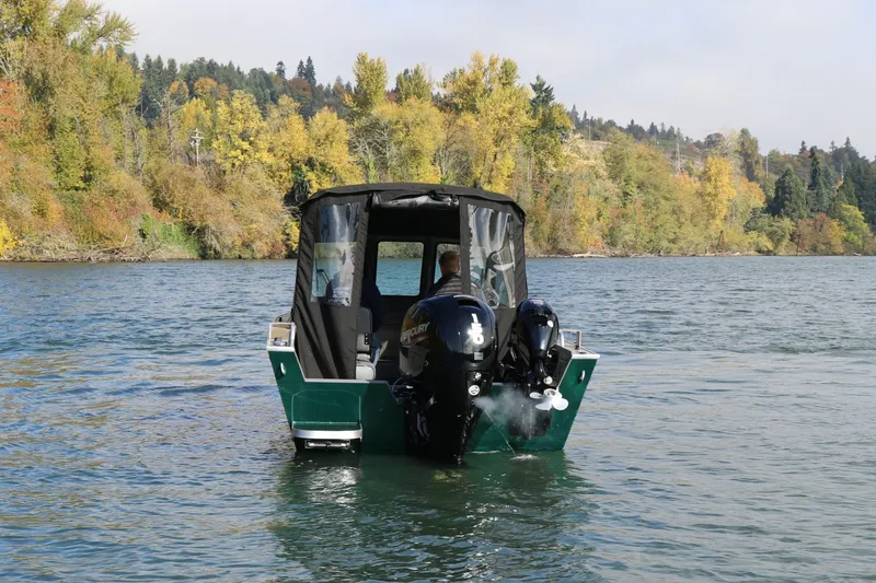 Slide: The Image of 2026 Alumaweld Stryker 220 boat cruising on a scenic river with autumn foliage. - 3