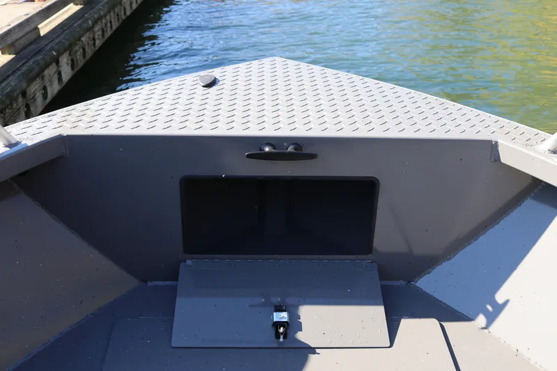 Slide: The Image of 2026 Alumaweld Stryker 220 boat interior with storage compartment, dockside view. - 33