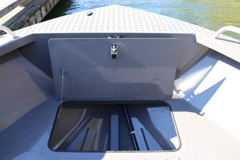 Slide: The Image of 2026 Alumaweld Stryker 220 boat storage compartment, open hatch, dockside view. - 34