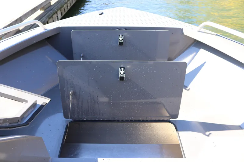 Slide: The Image of 2026 Alumaweld Stryker 220 boat interior with storage compartments, dockside view. - 35