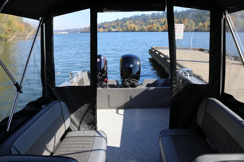 Slide: The Image of 2026 Alumaweld Stryker 220 boat interior with lake view and dock in background. - 38