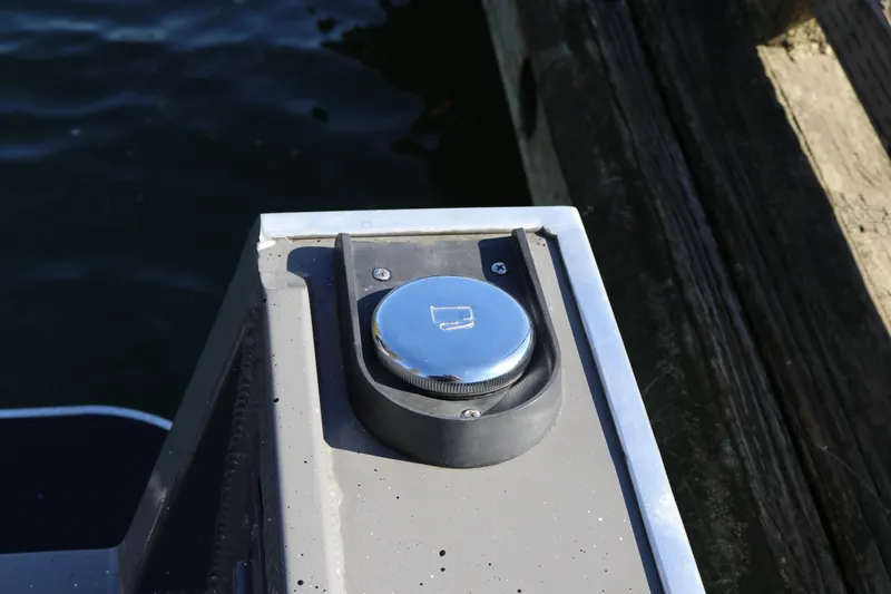 Slide: The Image of Fuel cap on 2026 Alumaweld Stryker 220 boat docked by water. - 39