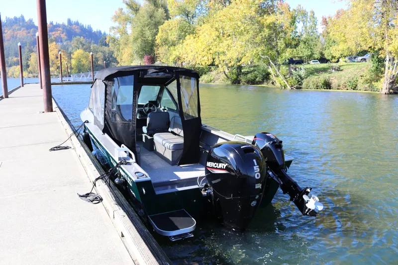 Slide: The Image of 2026 Alumaweld Stryker 220 boat docked on a scenic river with Mercury engine. - 4