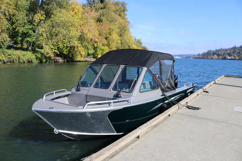 Slide: The Image of 2026 Alumaweld Stryker 220 boat docked on a scenic lake with autumn trees. - 42