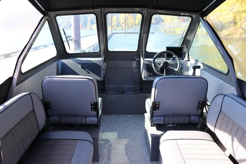 Slide: The Image of Interior of 2026 Alumaweld Stryker 220 boat with seating and steering wheel. - 5