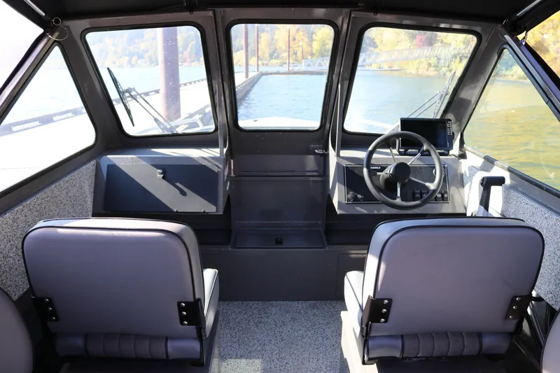Slide: The Image of Interior view of 2026 Alumaweld Stryker 220 boat cockpit with steering wheel and seats. - 6