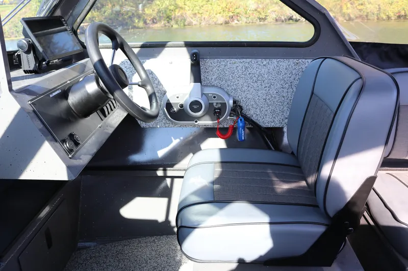 Slide: The Image of Interior of 2026 Alumaweld Stryker 220 boat, featuring steering wheel and comfortable seating. - 9