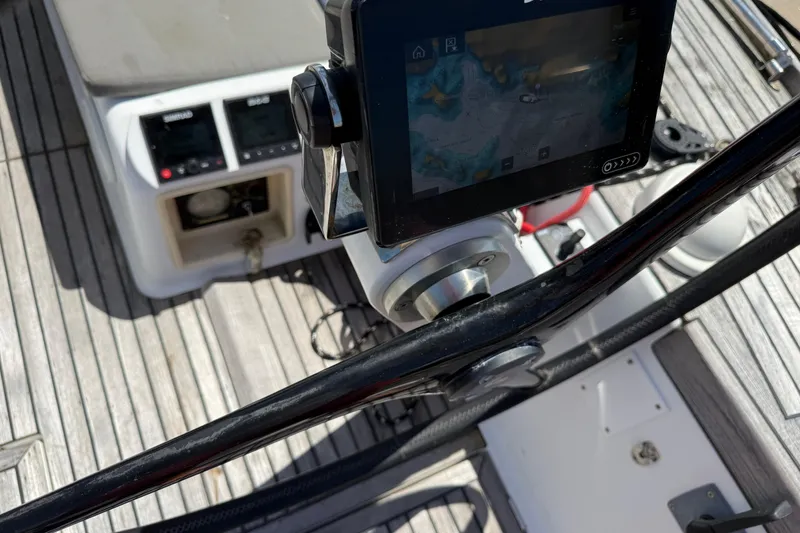 Slide: The Image of Cockpit of 2008 Beneteau First 50 sailboat with navigation equipment and wooden deck. - 10