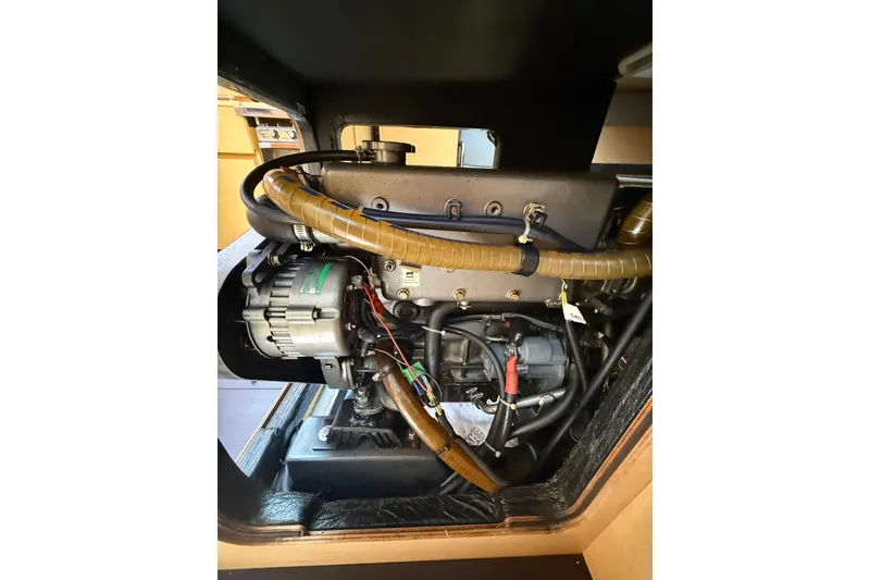 Slide: The Image of Engine compartment of a 2008 Beneteau First 50 sailboat, showcasing mechanical components. - 19