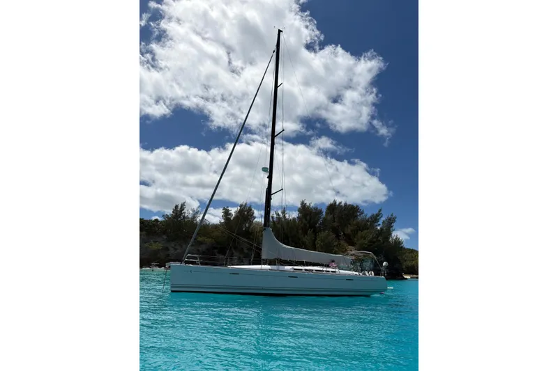 Slide: The Image of Sailing yacht Beneteau First 50, 2008 model, anchored in clear turquoise waters. - 2
