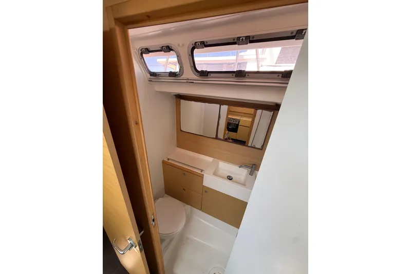 Slide: The Image of Bathroom interior of 2008 Beneteau First 50 yacht, featuring sink, toilet, and mirror. - 23