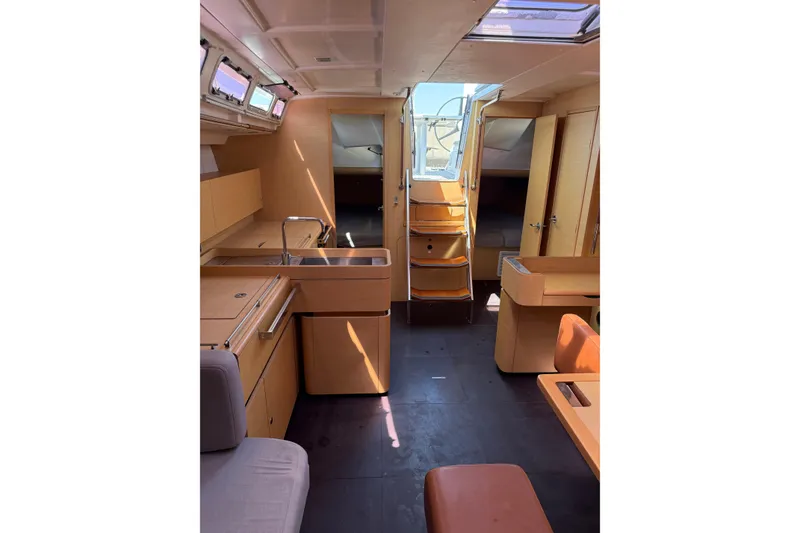 Slide: The Image of Interior of 2008 Beneteau First 50 yacht, featuring modern kitchen and seating area. - 28