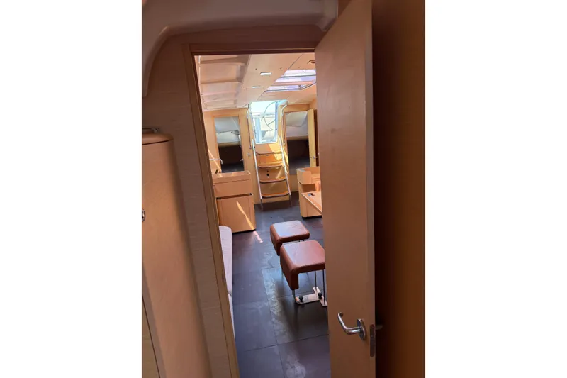 Slide: The Image of Interior view of 2008 Beneteau First 50 yacht, showcasing modern wooden furnishings and spacious layout. - 29