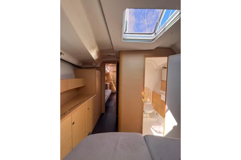 Slide: The Image of Interior of 2008 Beneteau First 50 yacht, featuring modern wood cabinetry and skylight. - 32