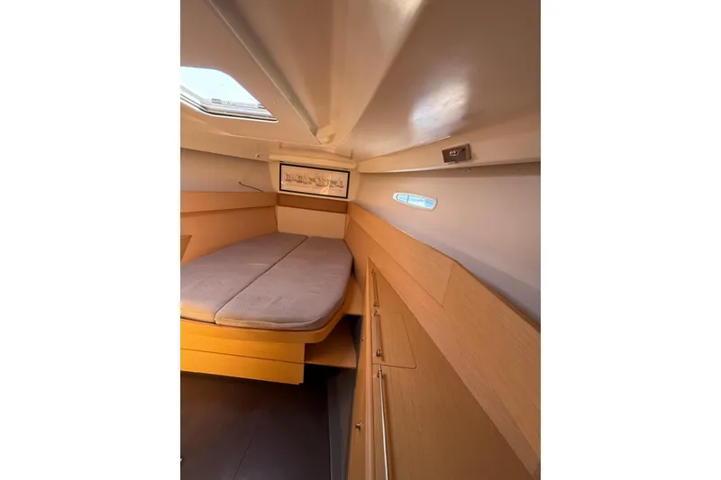 Slide: The Image of Interior cabin of 2008 Beneteau First 50 yacht, featuring a cozy bed and wooden finish. - 33