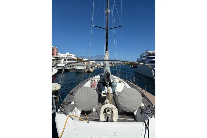 Slide: The Image of 2008 Beneteau First 50 sailboat docked in a marina, clear blue sky background. - 4