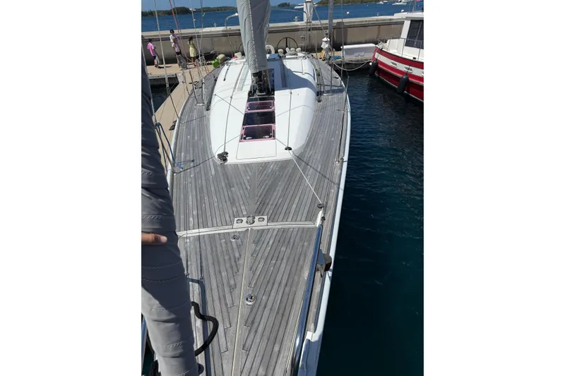 Slide: The Image of 2008 Beneteau First 50 sailboat docked, showcasing sleek deck design and marina setting. - 7