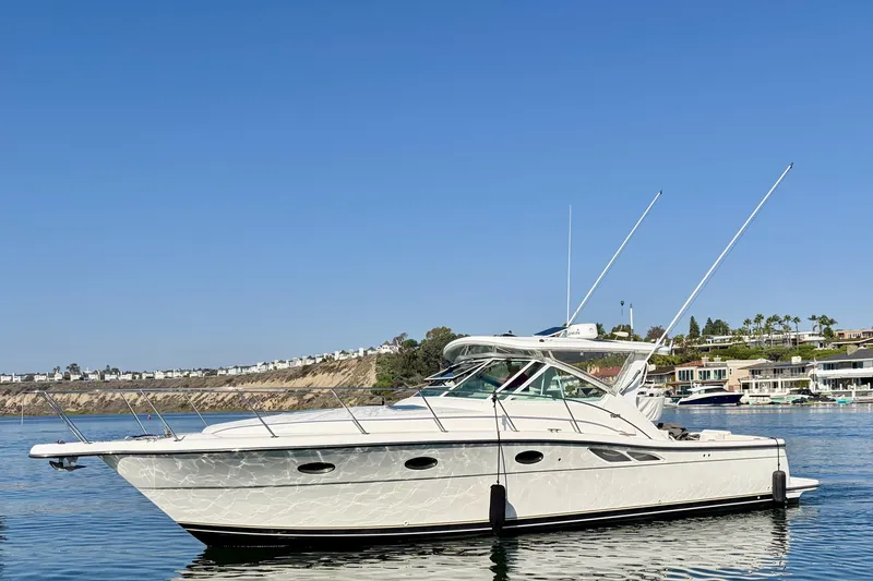 The Image of 2001 Tiara Yachts 3500 Open cruising on calm waters under a clear blue sky. - 0