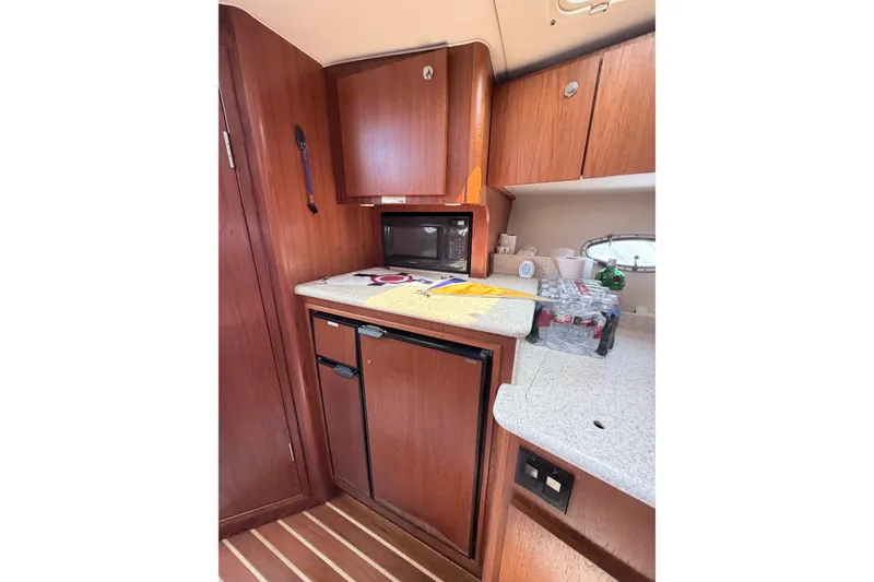 Slide: The Image of 2001 Tiara Yachts 3500 Open galley with wooden cabinetry and modern appliances. - 10