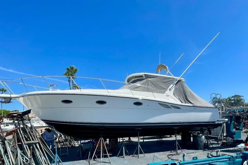 Slide: The Image of 2001 Tiara Yachts 3500 Open on dry dock under clear blue sky. - 4