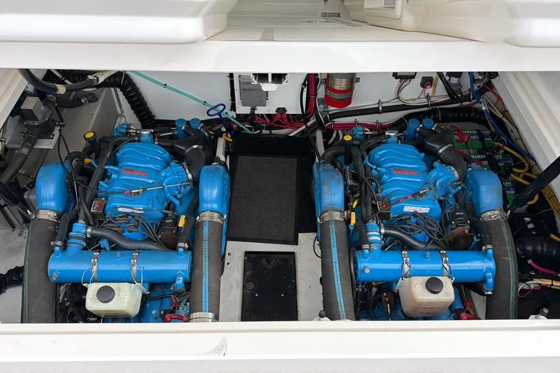 Slide: The Image of Engine compartment of a 2001 Tiara Yachts 3500 Open, featuring dual blue engines. - 8