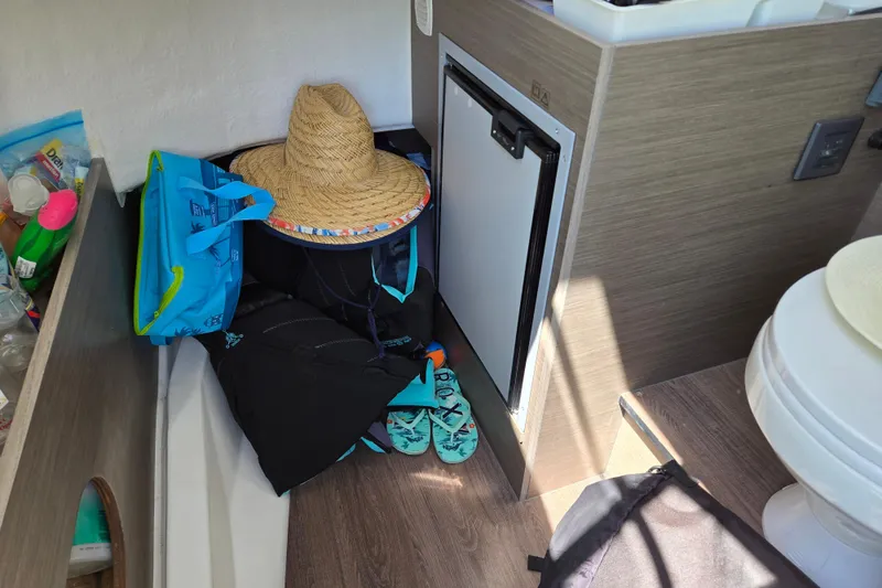 Slide: The Image of Interior of 2023 Beneteau Flyer 8 SPACEdeck with straw hat, bags, and flip-flops. - 16