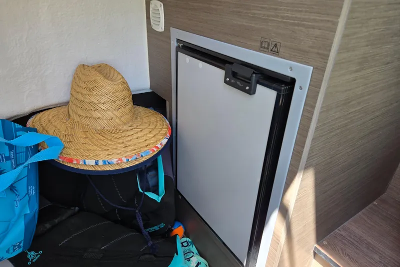 Slide: The Image of Straw hat and bags beside a compact fridge on Beneteau Flyer 8 SPACEdeck. - 17