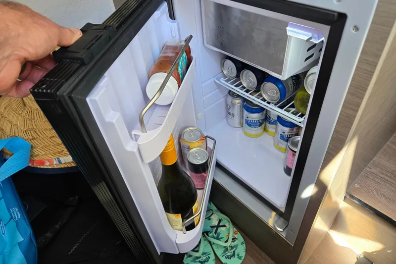 Slide: The Image of Mini fridge stocked with drinks on a 2023 Beneteau Flyer 8 SPACEdeck boat. - 24