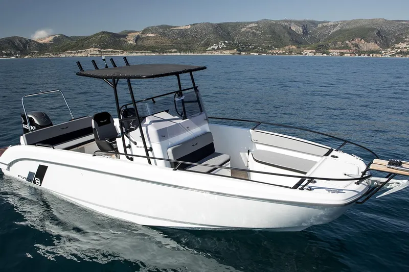 Slide: The Image of 2023 Beneteau Flyer 8 SPACEdeck boat cruising on open water with scenic mountain backdrop. - 26
