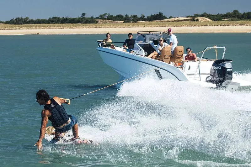 Slide: The Image of Wakeboarder riding behind 2023 Beneteau Flyer 8 SPACEdeck boat on a sunny day. - 27