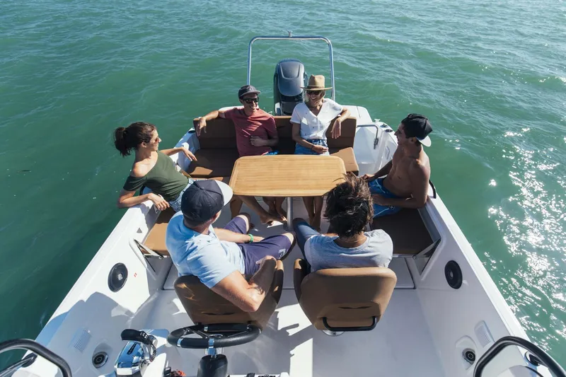 Slide: The Image of People relaxing on a 2023 Beneteau Flyer 8 SPACEdeck boat in open water. - 28