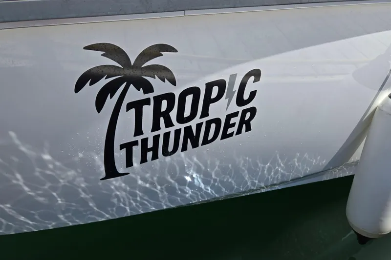 Slide: The Image of 2023 Beneteau Flyer 8 SPACEdeck with "Tropic Thunder" logo and palm tree graphic. - 4