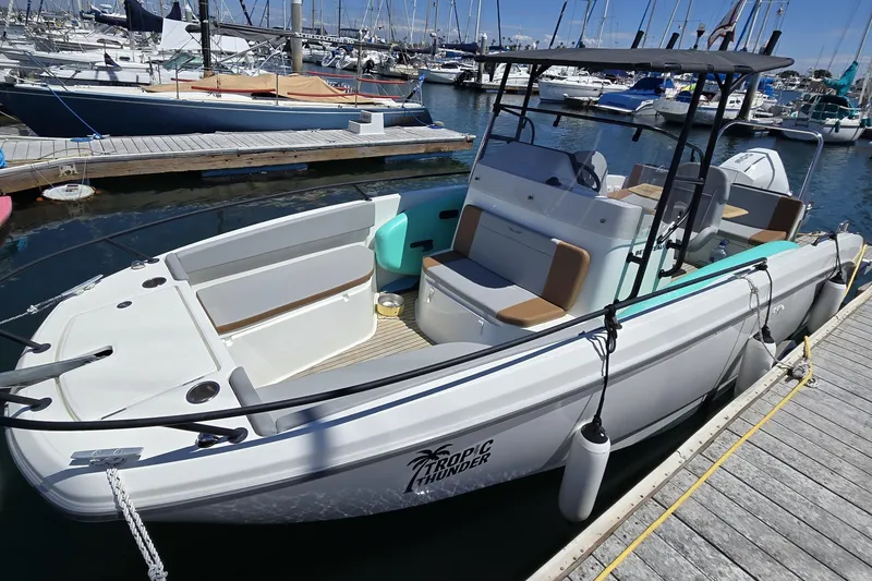 Slide: The Image of 2023 Beneteau Flyer 8 SPACEdeck boat docked at marina, featuring spacious seating and modern design. - 5
