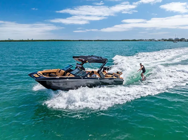 Slide: The Image of 2024 MasterCraft X24 boat with passengers enjoying a sunny day on the water. - 4